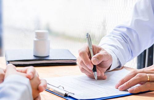 Diederich doctor signing paperwork