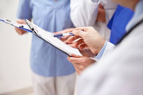 Diederich medical professionals looking at clipboard